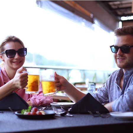 Grand Serendib Hotel Kandy Exterior photo A couple drinking beer